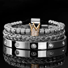 Elegant stainless steel bracelets featuring a gold crown accent and braided patterns, reflecting luxury and style.