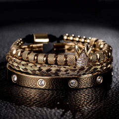 Stunning gold bracelets featuring intricate braids and sparkling crown detail, perfect for luxurious style.